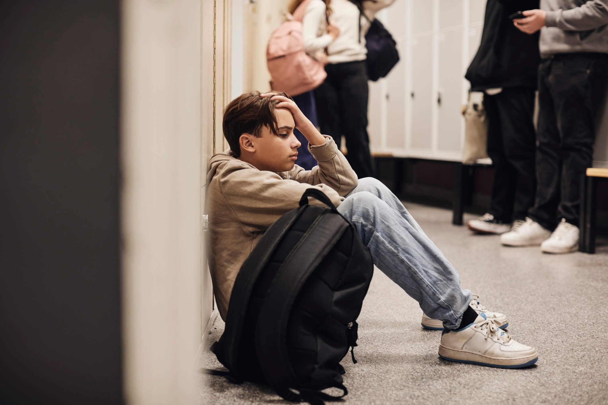 Teenager at School sitting in hallway